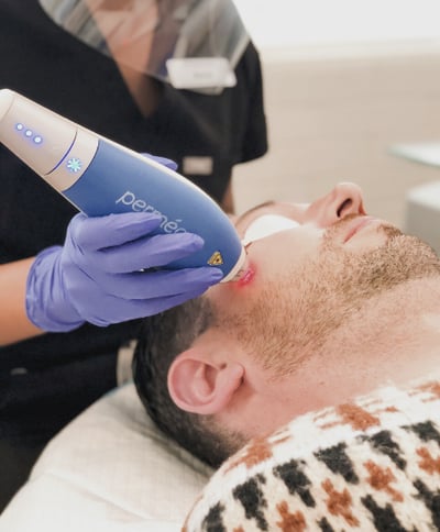 Man getting treatment in medical spa setting Man getting treatment in medical spa setting